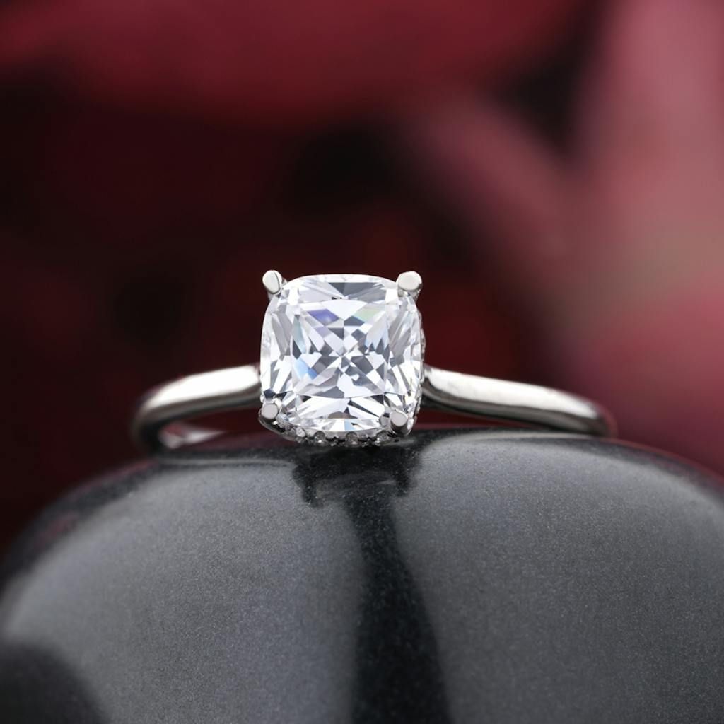 Close-up of a silver ring with a sparkling gemstone, perfect for jewelry displays.